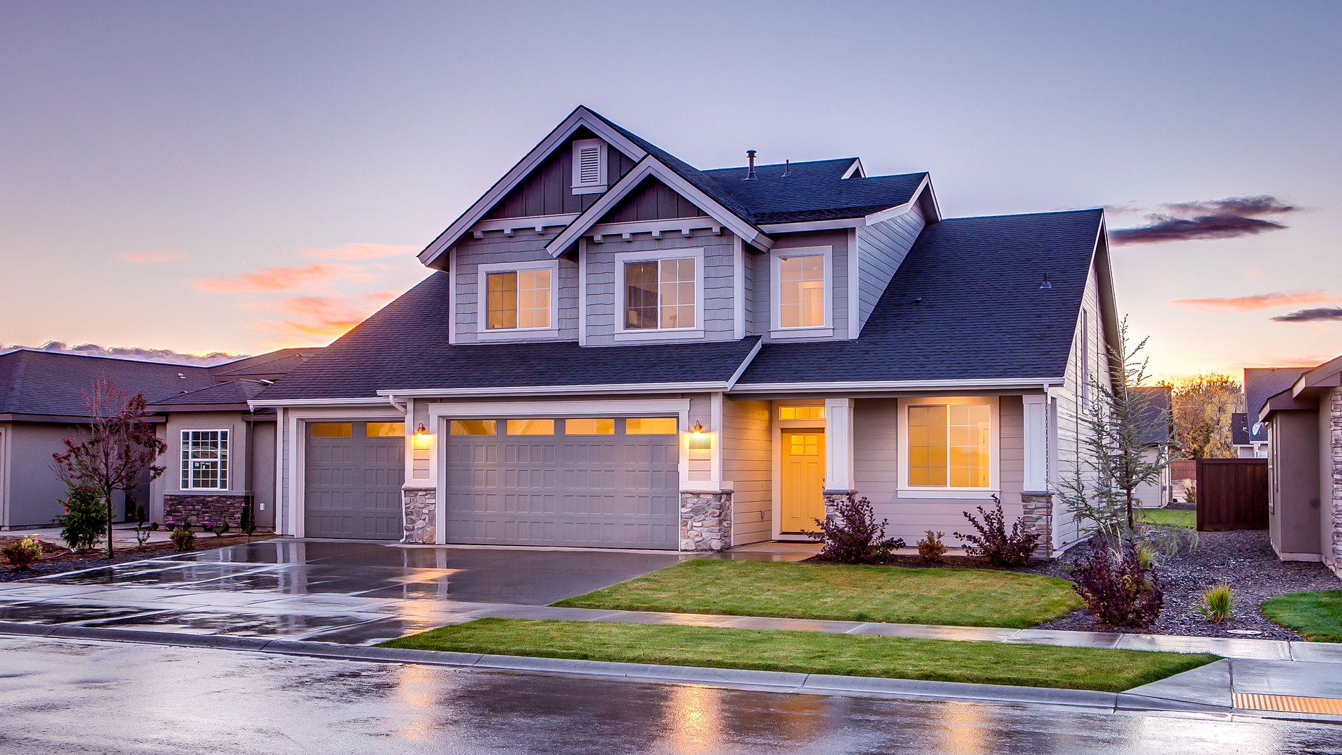 A two-story suburban home at dusk